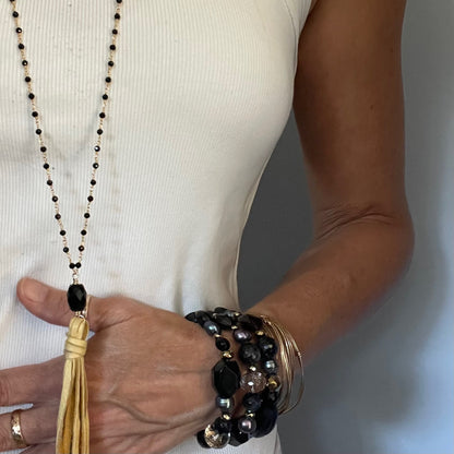 Black spinel and golden deer suede tassel